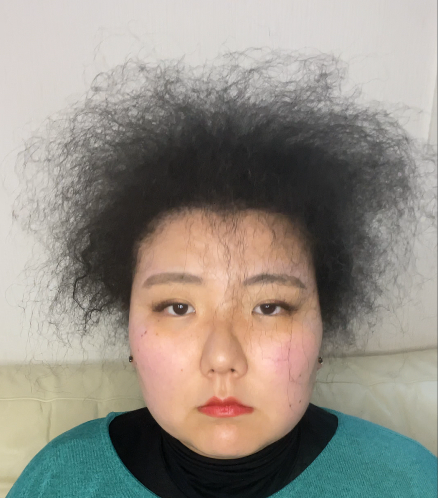 ちりちりくせ毛の女性の正面画像